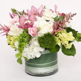 Pink and white floral arrangement in a glass vase