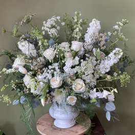 Large white floral arrangement in a white vase