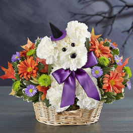 Dog-shaped floral basket with white blooms, orange flowers, and a purple bow