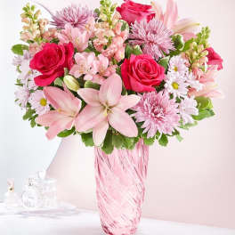 Pink and white mixed bouquet in a pink glass vase