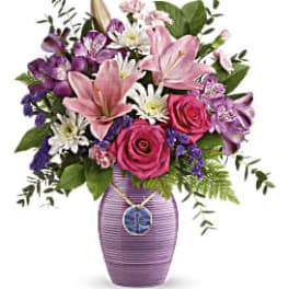 Pink lilies and roses in a purple vase