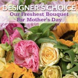 Close-up of a mixed bouquet with yellow roses, pink blooms, and bright sunflowers for Mother's Day