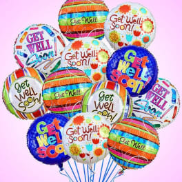 Cluster of colorful get well soon balloons on a pink background