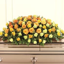 Large casket spray of yellow and orange roses