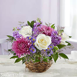 Basket arrangement of white roses, pink and purple flowers