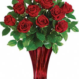 Bouquet of red roses in a red glass vase