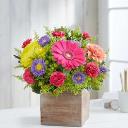 Colorful mixed bouquet in a wooden cube vase