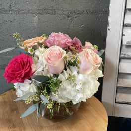 Bouquet of pink and white roses with hydrangeas in a glass vase