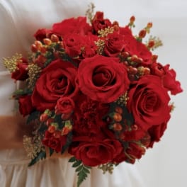 Bouquet of red roses with small berry accents