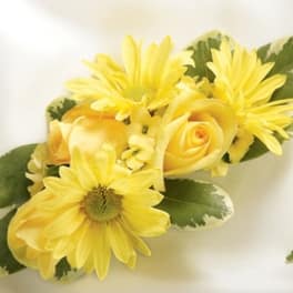 Yellow rose and daisy boutonniere with variegated leaves