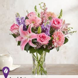 Pink and purple mixed bouquet in a clear glass vase
