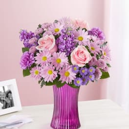 Pink and purple bouquet in a magenta vase