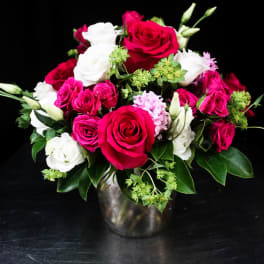 Bouquet of red and white roses in a metal vase