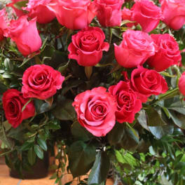 Pink roses arranged in a clear glass vase