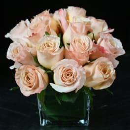 Bouquet of pale peach roses in a clear glass vase