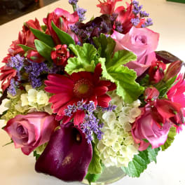 Mixed bouquet of pink roses, red gerberas, purple calla lilies, and hydrangeas
