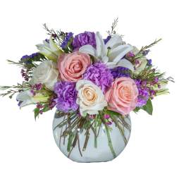 Bouquet of pink and white roses with purple flowers in a glass vase