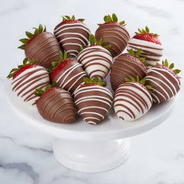 Plate of chocolate-covered strawberries on a white pedestal stand