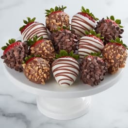 Plate of chocolate-covered strawberries on a white pedestal stand