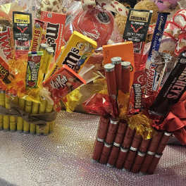 Gift bouquets made of candy bars and snack packs arranged in cellophane