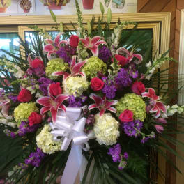 Large standing floral spray with pink lilies, roses, and hydrangeas