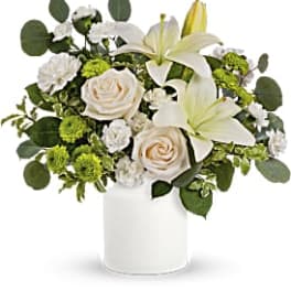 White lilies and roses in a white vase