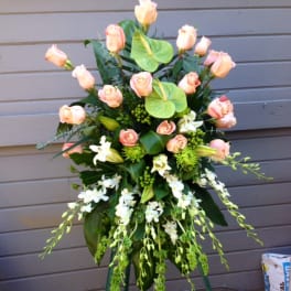 Tall floral spray with peach roses and white orchids