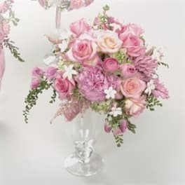 Pink and white rose bouquet in a clear glass vase
