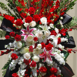 Large red and white standing floral spray with lilies and roses