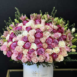 Large pink and white rose arrangement in a white hat box