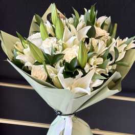 White lily and rose bouquet wrapped in pale green paper