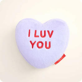 Heart-shaped plush pillow with "I LUV YOU" text