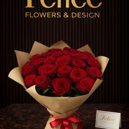 Bouquet of red roses wrapped in brown paper with a red ribbon