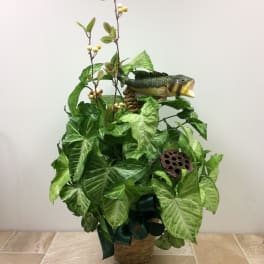 Basket arrangement of green foliage with a fish decoration