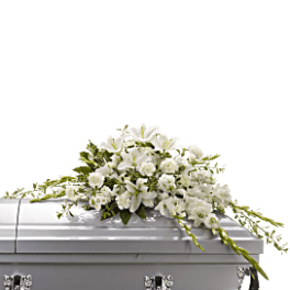 White floral casket spray on a silver casket