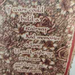 Decorative wall hanging with floral pattern and a memorial quote