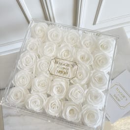 Box of white roses in a clear square gift box