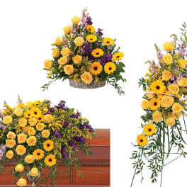 Yellow roses and daisies arranged in a casket spray and standing spray.