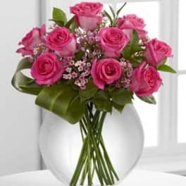 Pink roses arranged in a clear glass vase