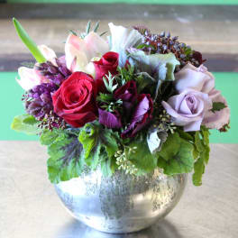 Mixed bouquet of roses and lilies in a silver vase