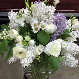 White and lavender mixed bouquet in a glass vase