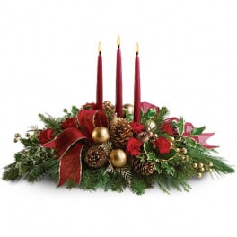 Christmas centerpiece with red carnations, pinecones, gold ornaments and three red taper candles