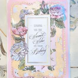 Birthday card with pastel floral border and gold trim