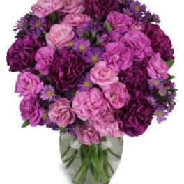Pink and purple bouquet in a clear glass vase
