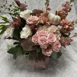Pink and white rose bouquet with mums and a small white pumpkin