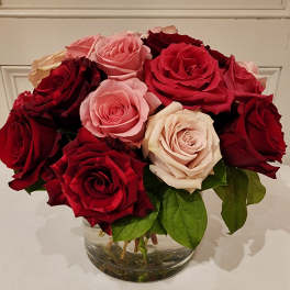 Bouquet of red and pink roses in a clear glass vase