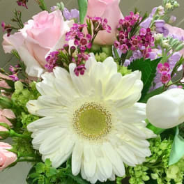 Bouquet of pink roses, white gerbera daisies, and purple filler flowers
