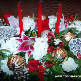 Red and white floral centerpiece with tall red candles