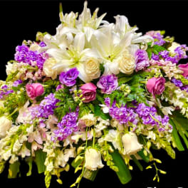 Large bouquet of white lilies, cream roses, and purple flowers