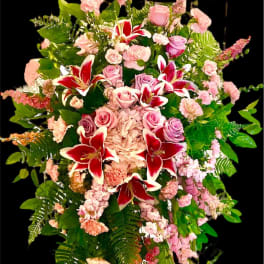Tall standing floral spray with pink roses and red lilies